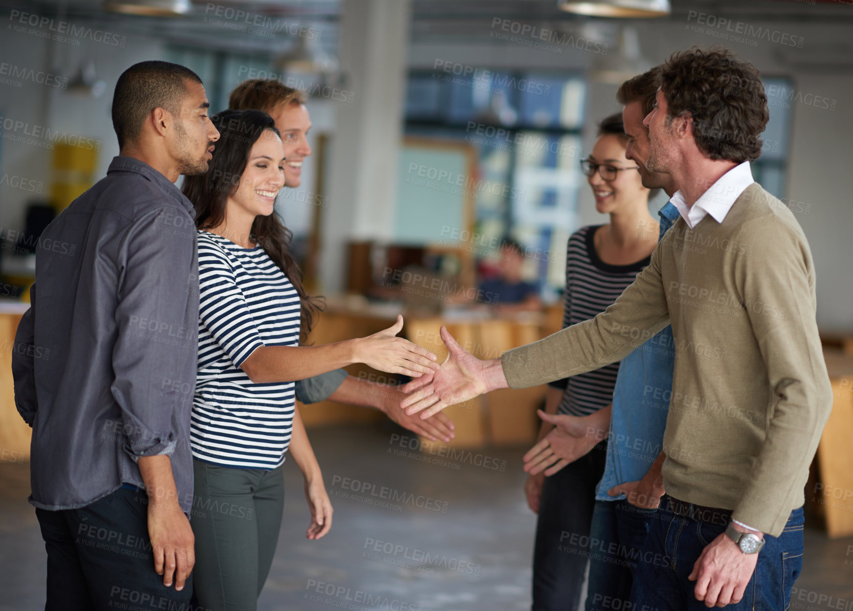 Buy stock photo Creative professionals greeting each other in an open office space