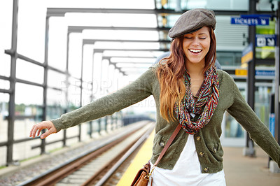 Buy stock photo Happy, woman and railway for travel at train station with freedom, subway and transport of morning journey. Smile, girl and balance on platform for waiting, commute and metro delay of departure