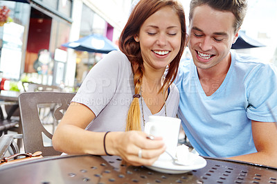 Buy stock photo A happy couple having a coffee at an outside cafe
