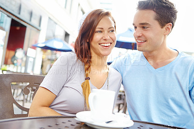 Buy stock photo A happy couple having a coffee at an outside cafe with copyspace