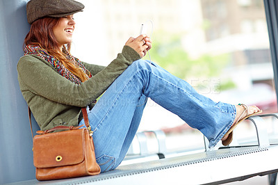 Buy stock photo Train station, woman and smile on smartphone with earphones for streaming music and audio. Female person, outside and happy with texting on internet, social media and message for communication