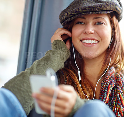 Buy stock photo Close up of a beautiful girl listening to music on her phone