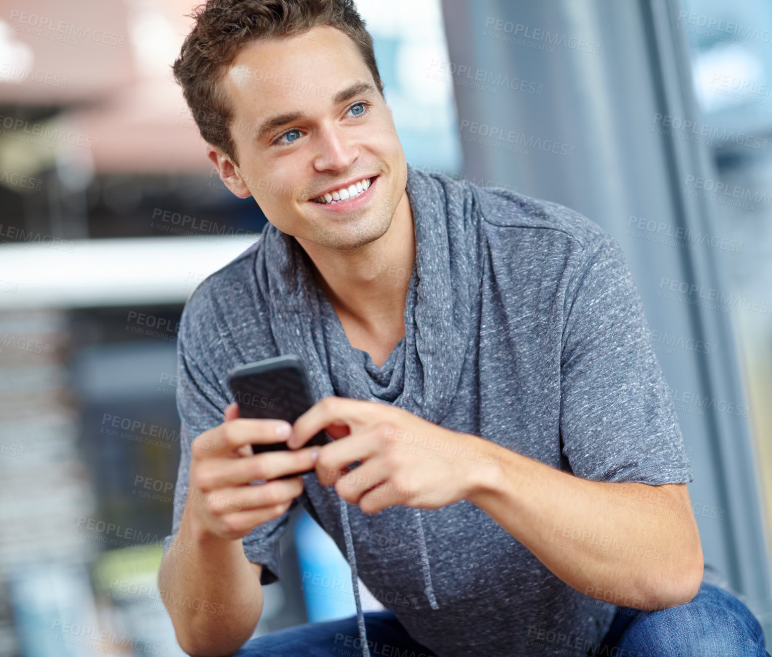 Buy stock photo Man, phone and thinking at bus stop for travel, chat and streaming with app, social media and web. Male person, mobile and smile at station for ebook, commute and podcast with email communication