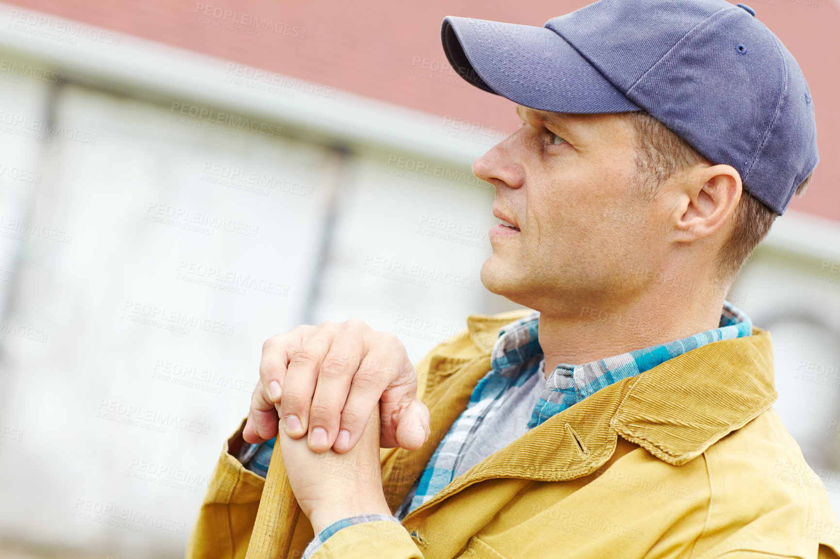 Buy stock photo Profile of a man leaning on a gardening tool with copyspace