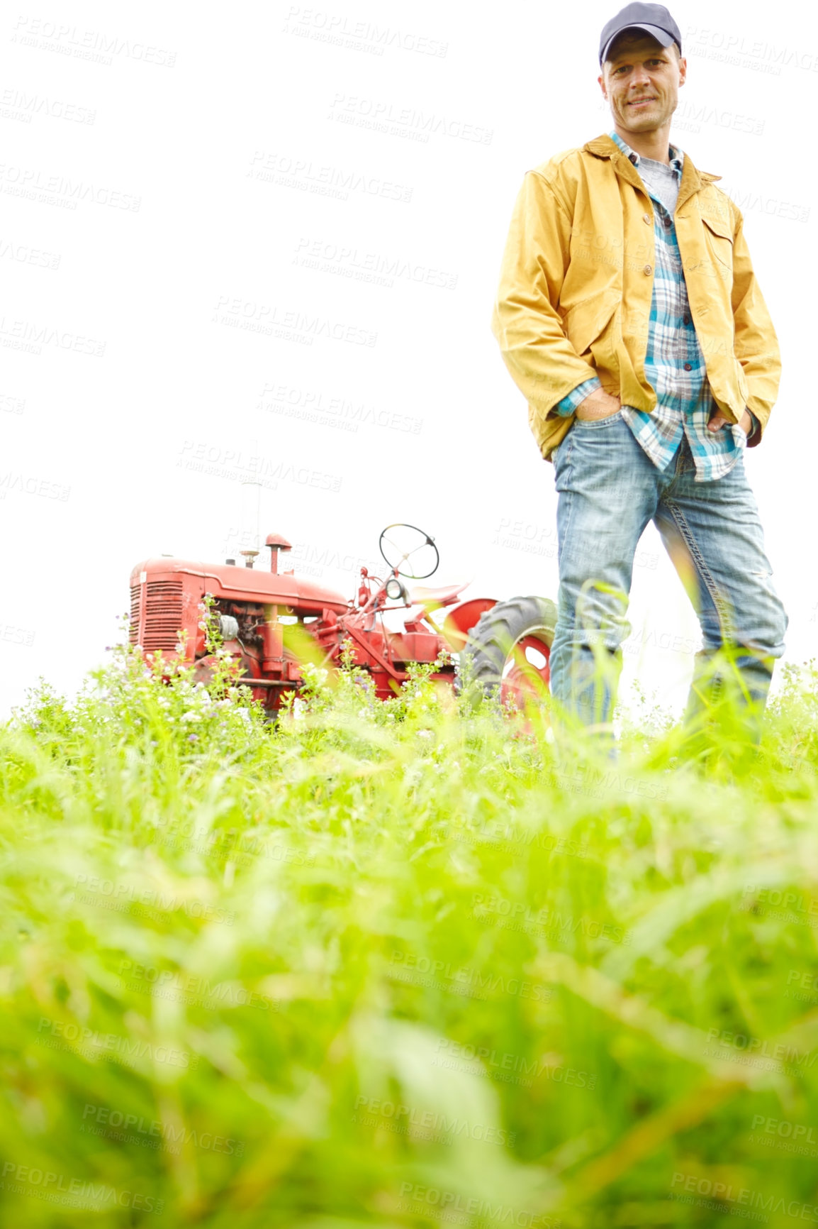 Buy stock photo Full length portrait of a farmer standing in a field with a tractor parked behind him - Copyspace