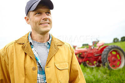 Buy stock photo Farmer, thinking and smile with tractor outdoor for agriculture transport, harvest industry and sustainability. Man, machine truck and environment with field production, eco friendly and countryside