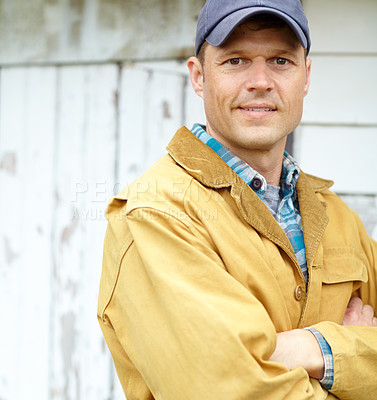 Buy stock photo Portrait of a handsome man with his arms folded and a smile on his face