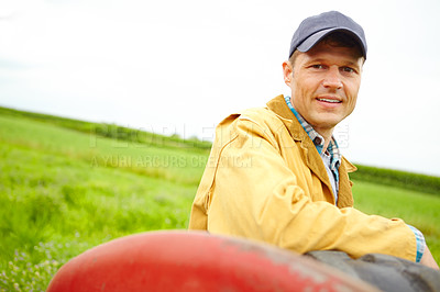 Buy stock photo Tractor, farm and portrait of man in field for harvesting plants, growth and vegetable crops. Agriculture, transport and farmer by vehicle for sustainability, agro business or produce in countryside