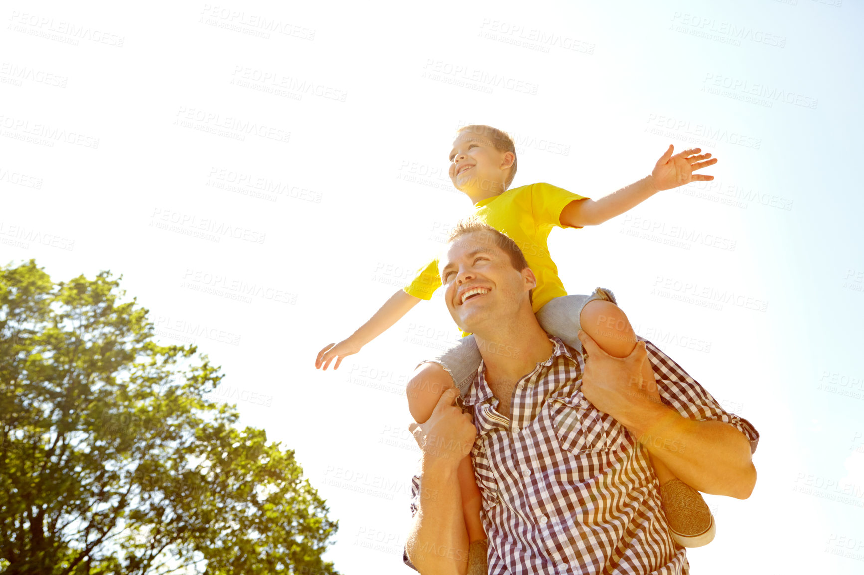 Buy stock photo Park, sky and dad with boy on shoulder ride with happiness for fun, playing and bonding. Parent, kid and smile or laugh with open arms for support, care and trust on break for child development