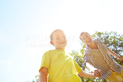 Buy stock photo Cute young boy pulling his dad by the hand to show him something outdoors