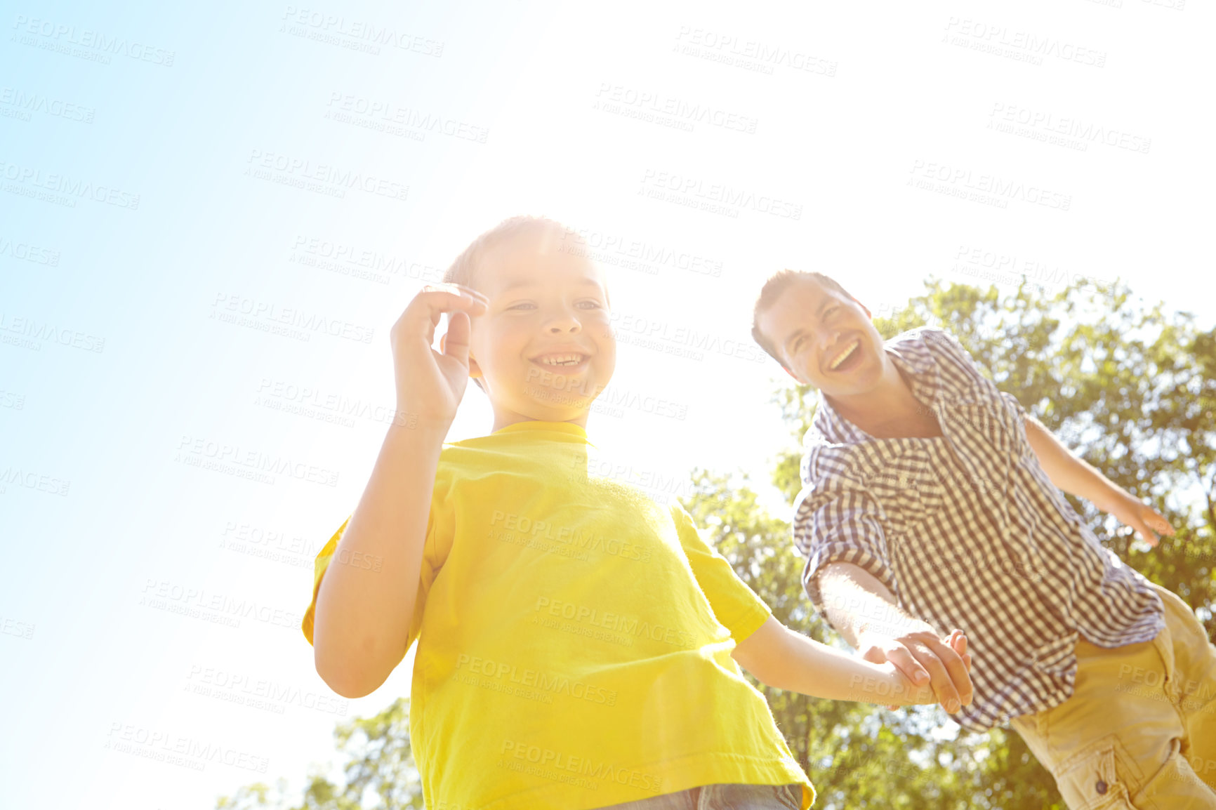 Buy stock photo Games, father and boy holding hands in nature for low angle fun, playing and family bonding in garden park. Blue sky space, happy and son with single parent, dad and man in backyard for summer break