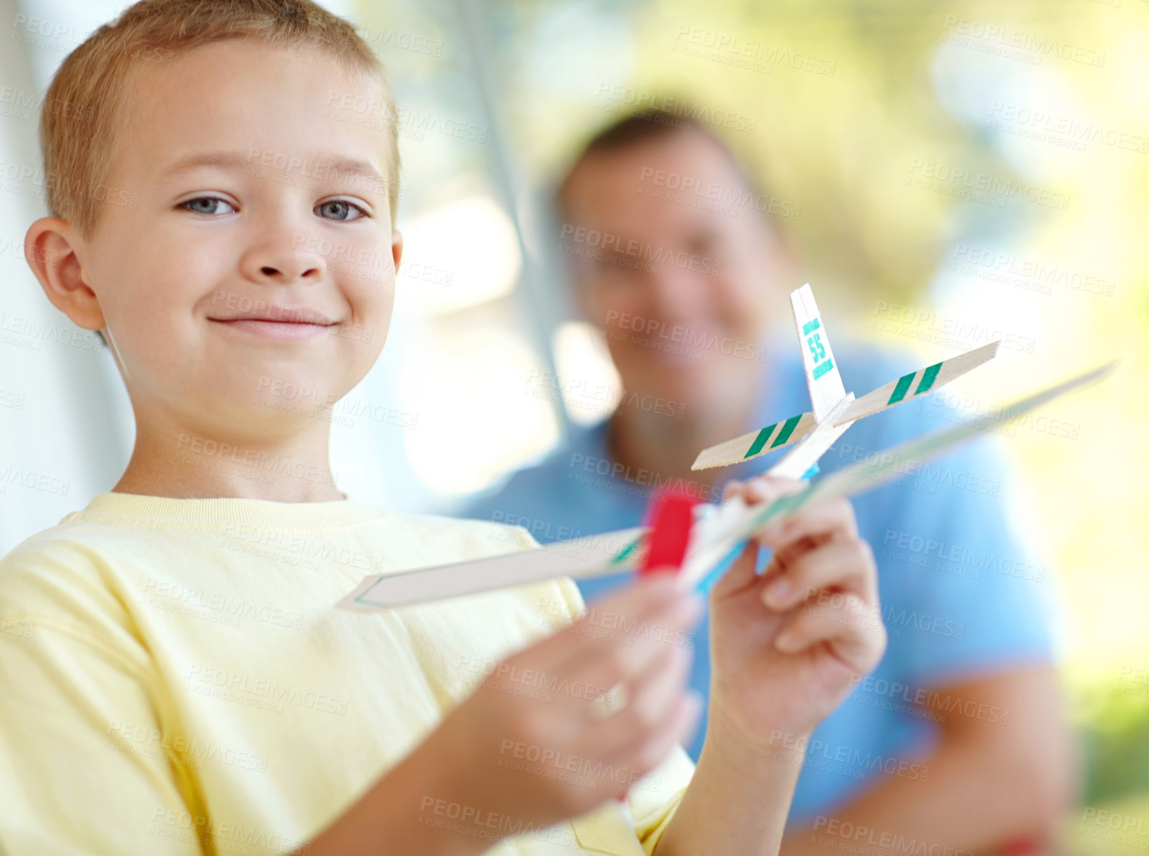 Buy stock photo Toys, airplane and portrait of boy with dad, smile and playful fun on patio together for morning bonding. Playing, weekend games, and happy child in backyard with paper plane, father and son in home