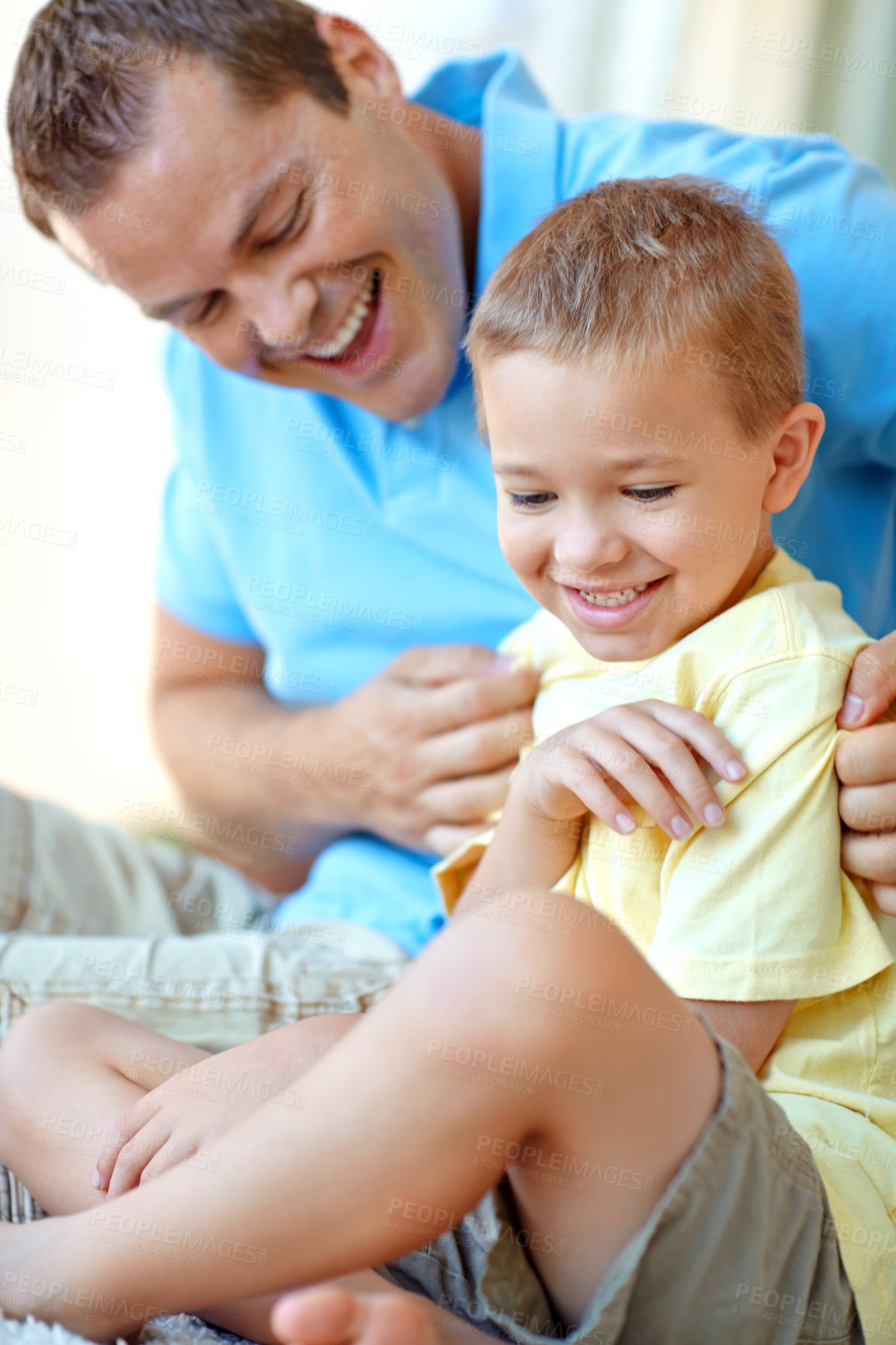 Buy stock photo Father, tickling and son for fun at house with playful game, bonding together and love of healthy relationship. Smile, man and child with funny morning, weekend break and family support at apartment