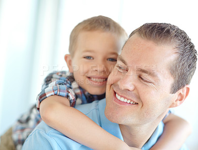 Buy stock photo Happy, father and child hug in family home with fun, bonding and love in living room. Smile, play wrestling and youth with parent care, support and piggy back game with kid and embrace together