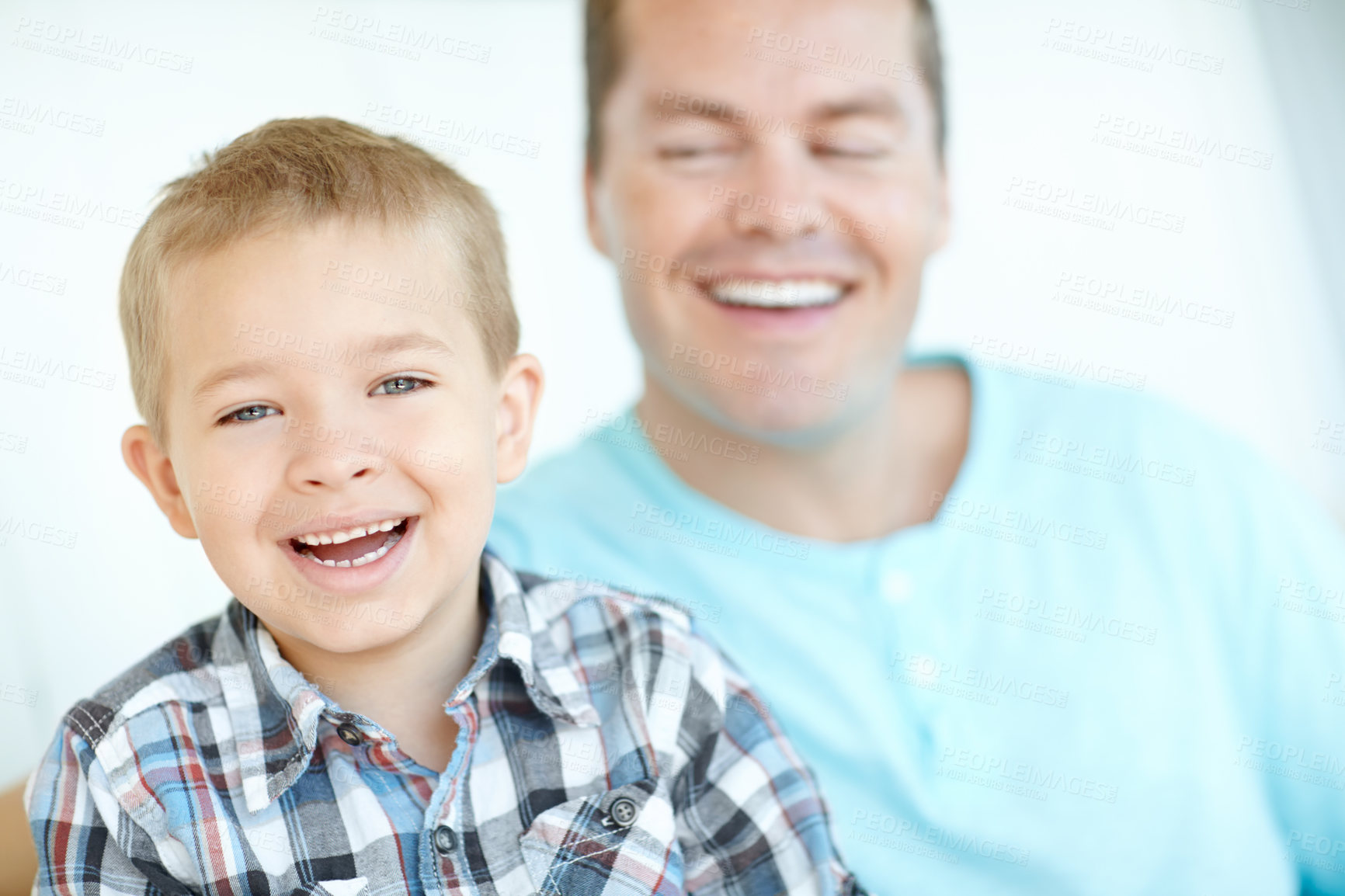 Buy stock photo Father, child and relax with smile at house for safety, parental support and bonding together of weekend break. Laughing, man and son with funny joke for family love, relationship and calm morning