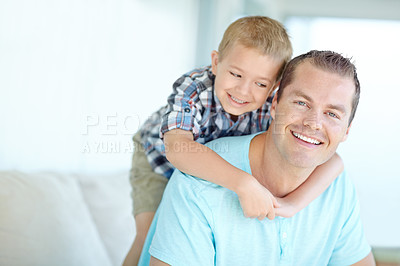 Buy stock photo Boy, dad and hug on sofa in home with portrait, bonding and love for games, relax and connection in living room. Child, father and happy with memory, piggy back and embrace at family house in Germany