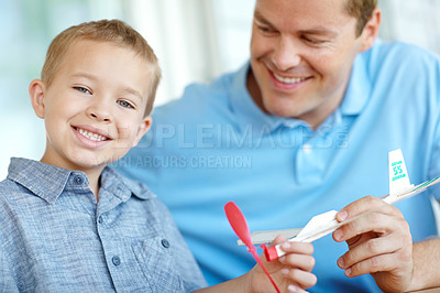 Buy stock photo Airplane, model and portrait of dad with child with toys for bonding, relationship and creativity. Family, happy and father with boy building aeroplane for games, entertainment and relax in home