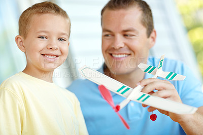 Buy stock photo Airplane, toys and portrait of dad with child with smile for bonding, relationship or creativity. Family, happy and father with boy building model aeroplane for games, entertainment and relax in home