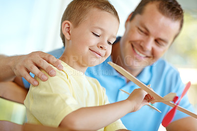 Buy stock photo Toys, plane and playful boy with dad, smile and fun on outdoor patio together for morning bonding. Playing, weekend games and happy child on porch with paper airplane, father and son laughing in home