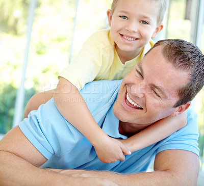 Buy stock photo Happy, dad and child playing in family home with fun, bonding and love in living room. Smile, wrestle and youth with parent care, support and laugh from game with hug and embrace on the floor