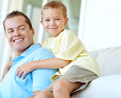 Buy stock photo Boy, dad and hug on couch for portrait in home, bonding or love with support for connection in morning. Child, dad and happy man with security, pride and relax in lounge at family house in France