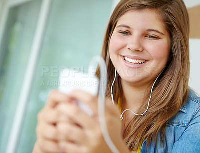 Buy stock photo Girl, teenager and phone for audio in home, earphones and app for listening to techno playlist. Female person, online and subscription to website for podcast, surfing social media and relax on sofa