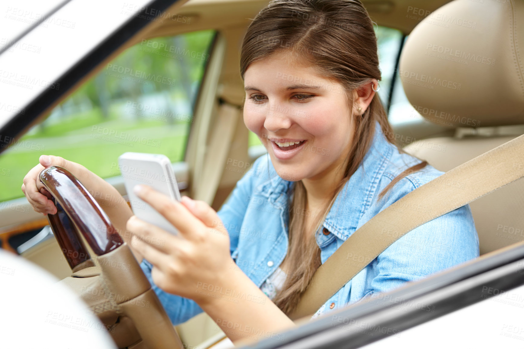 Buy stock photo Happy woman, car or window with phone for drive, destination or commute in neighborhood. Young, female person or driver with smile on mobile smartphone for navigation or location app in motor vehicle