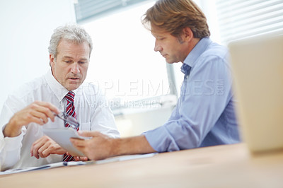 Buy stock photo Two male business associates sitting and discussing strategy in the office
