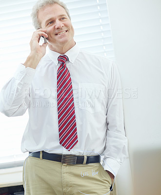 Buy stock photo Mature, attractive male associate having a mobile phone conversation
