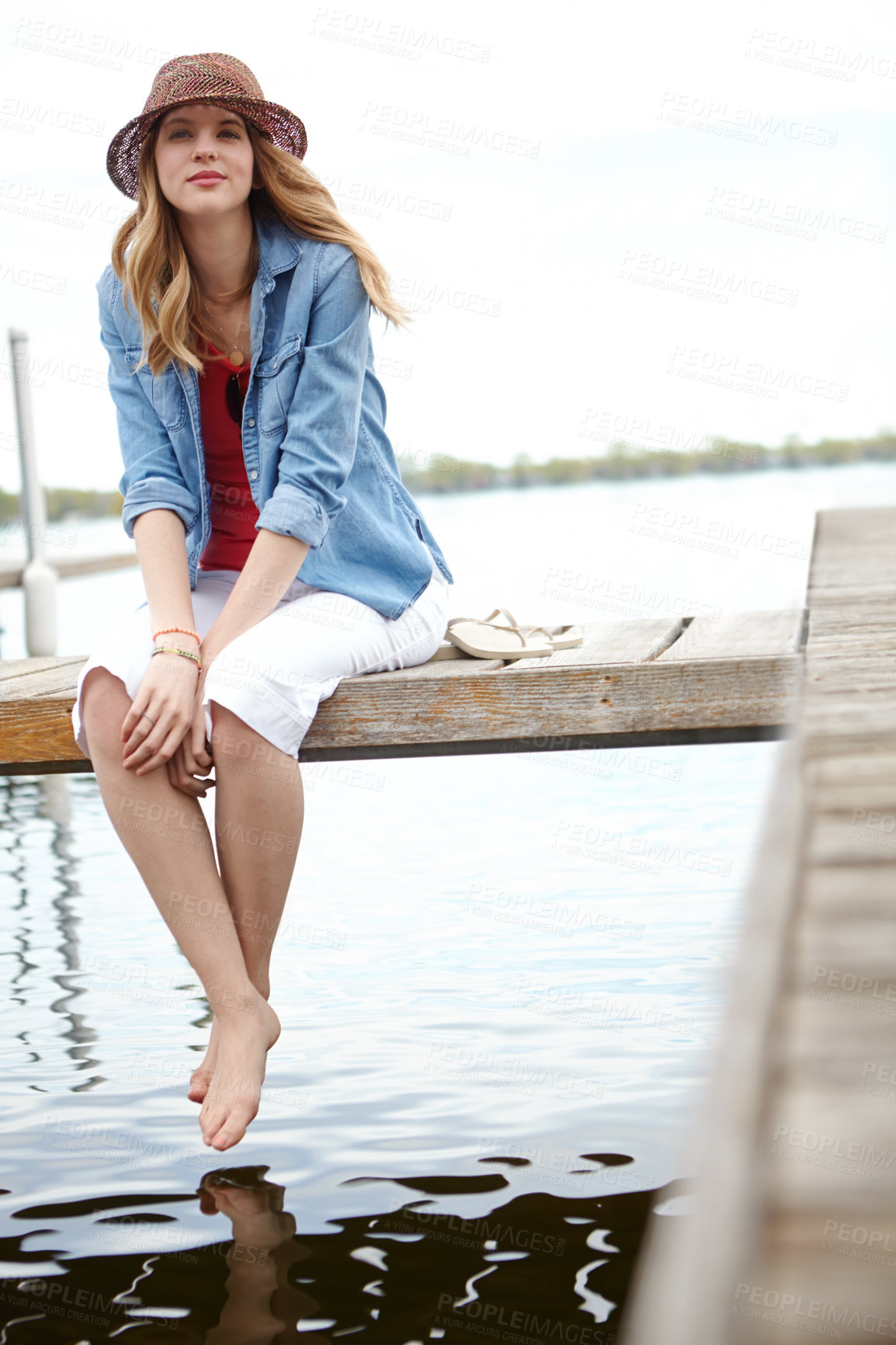 Buy stock photo Portrait, woman and jetty on lake for vacation, break or holiday with happiness, feet or relax. Female person, smile and travel on pier for freedom, outdoor adventure or peace as tourist in Indonesia