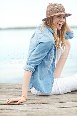 Buy stock photo Woman, lake and smile with environment, thinking and relax for adventure, holiday or happy on travel journey. Girl, tourist and dock with calm in nature, vacation or sightseeing by water in Denmark