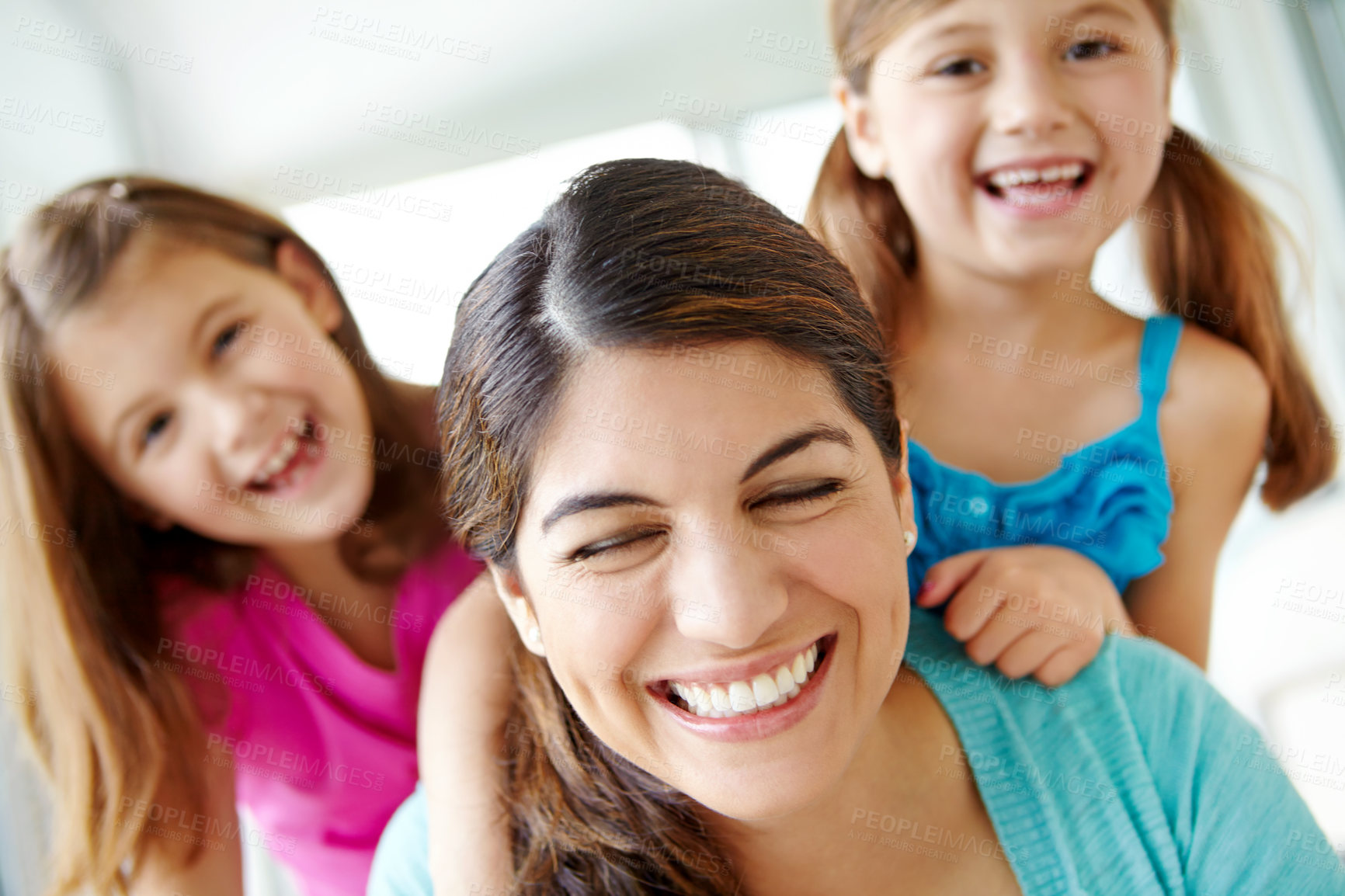 Buy stock photo Playful, children and happy with mother in home for support, development and bonding on weekend. Family love, fun and girl kids with smile by woman in house for care, connection and relaxing together