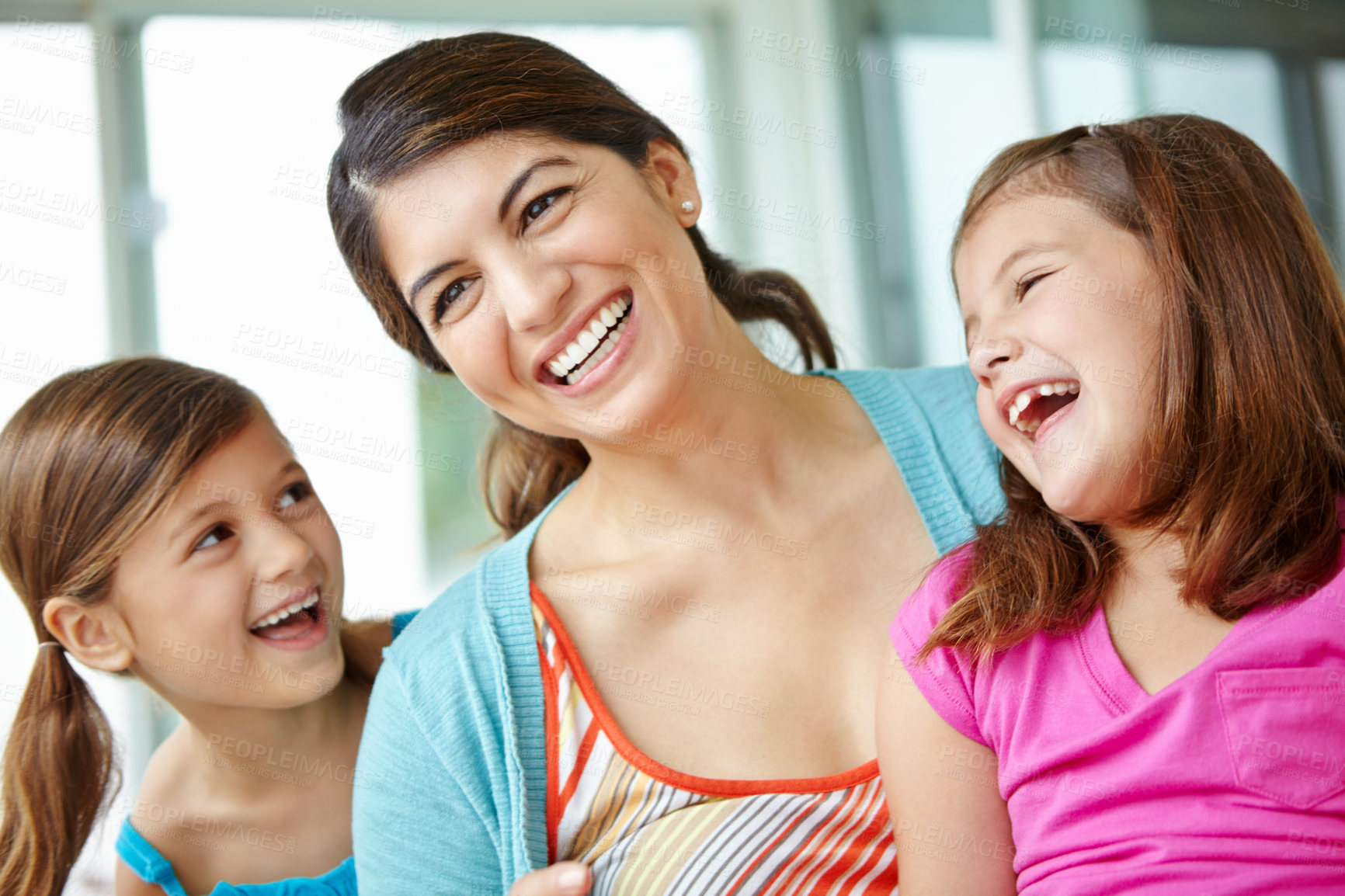 Buy stock photo Happy, children and laughing with woman in house for bonding, development or connection on weekend. Family love, fun and girl kids with smile by mother at home for care, support and relaxing together