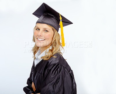 Buy stock photo Cap and gown-clad young woman smiling while isolated on white