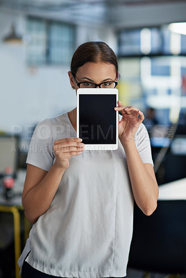 Buy stock photo Young businesswoman holding a digital tablet up to her face and peeping over it