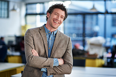 Buy stock photo Smiling mature man standing with his arms crossed in an open office space