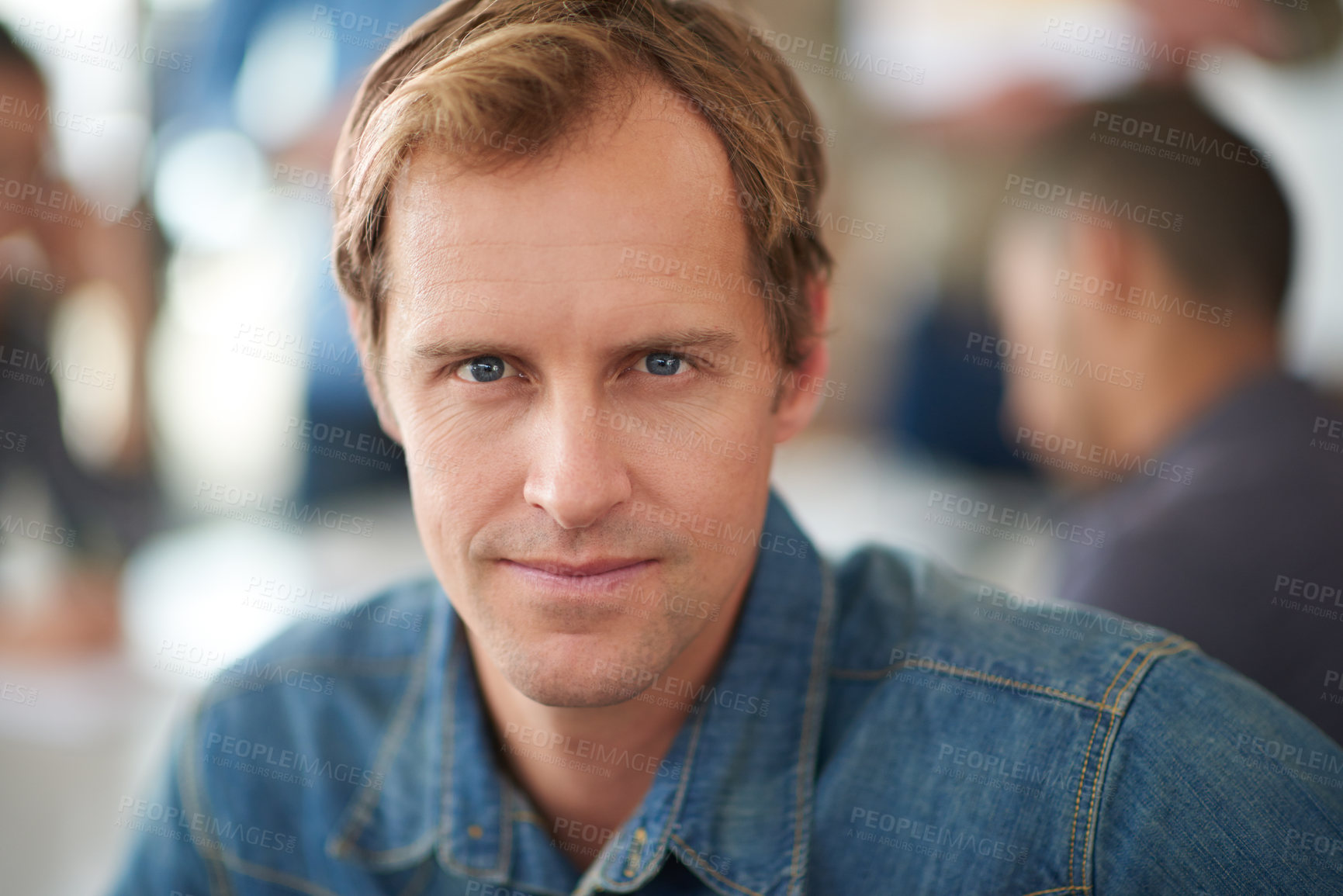 Buy stock photo Shot of a handsome young man sitting in a meeting