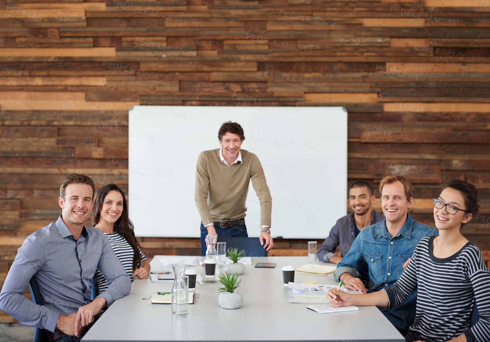 Buy stock photo Portrait of a group of coworkers sitting at a conference table during a presentation