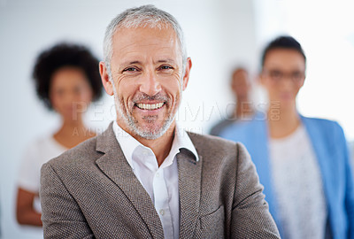 Buy stock photo Happy mature man with colleagues in the background