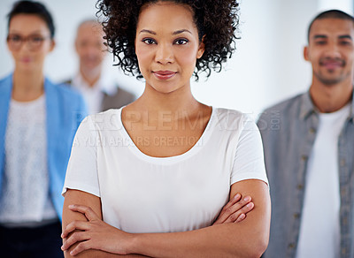 Buy stock photo Beautiful young businesswoman with coworkers in the background