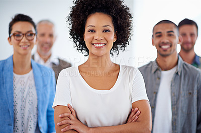Buy stock photo Beautiful young businesswoman smiling with coworkers in the background