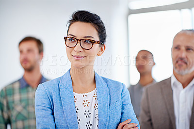 Buy stock photo Young businesswoman looking away with colleagues in the background