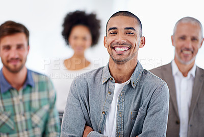Buy stock photo Portrait of smiling young man with colleagues in the background
