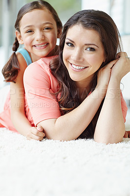 Buy stock photo Cute young mother and daughter relaxing while lying on the floor at home