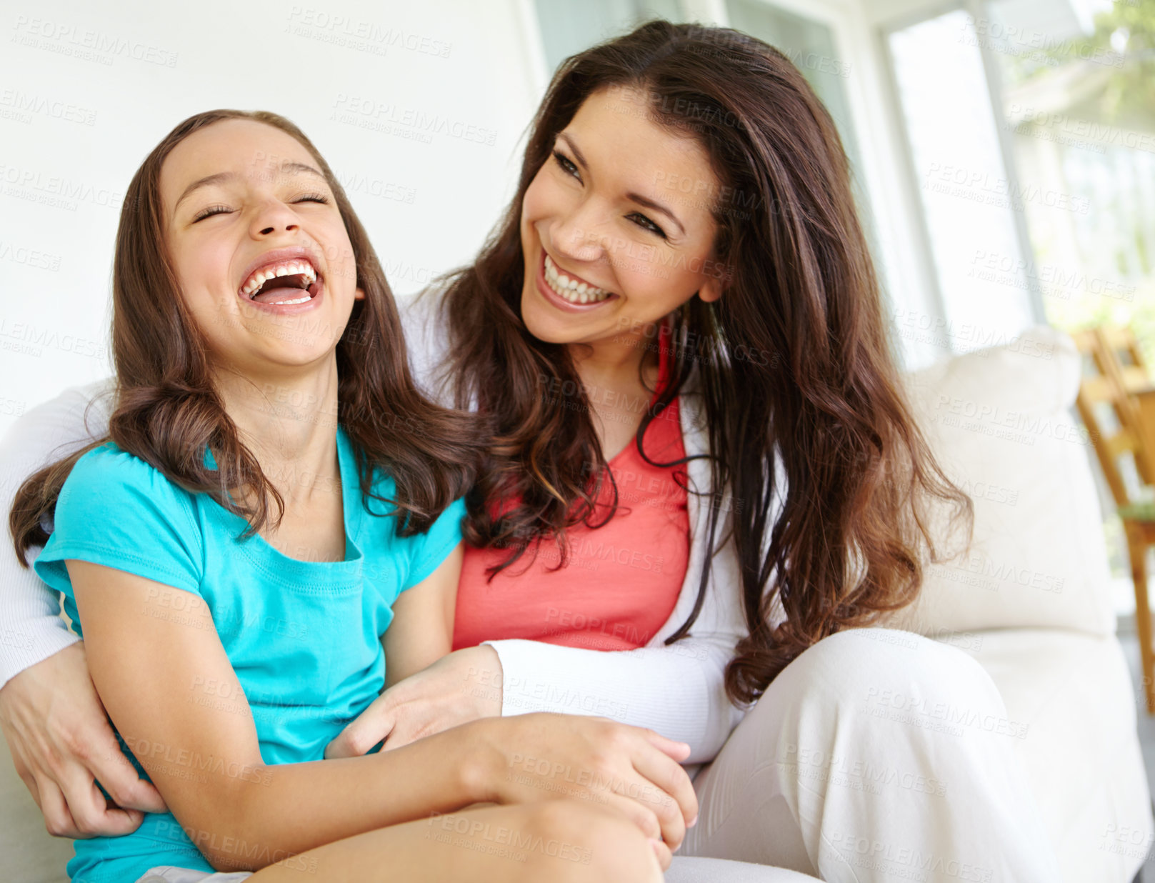 Buy stock photo Girl, mom and playing on couch with laugh for mother and daughter bonding on weekend with childhood fun. Parent, kid and happy together in house with love or affection, care and tickle game on sofa.