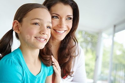 Buy stock photo A cute daughter with pigtails looking off camera with her mother with copyspace