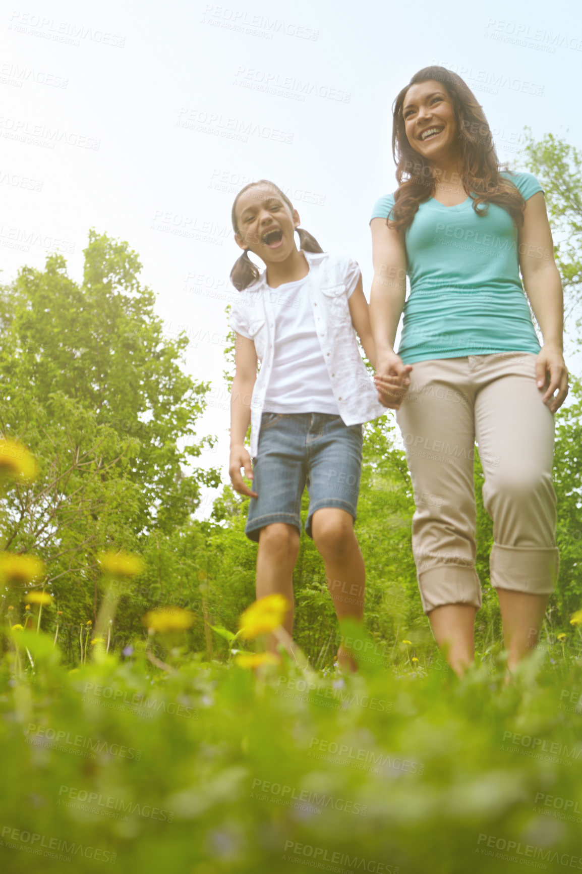 Buy stock photo Mother, girl and conversation in nature, holding hands and outdoor for family bonding on vacation. Mama, daughter and countryside trip for love on weekend, security and walking together on holiday