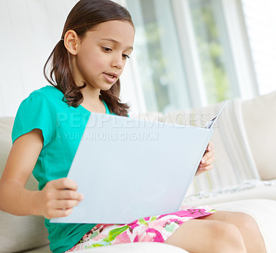 Buy stock photo A little girl reading her book