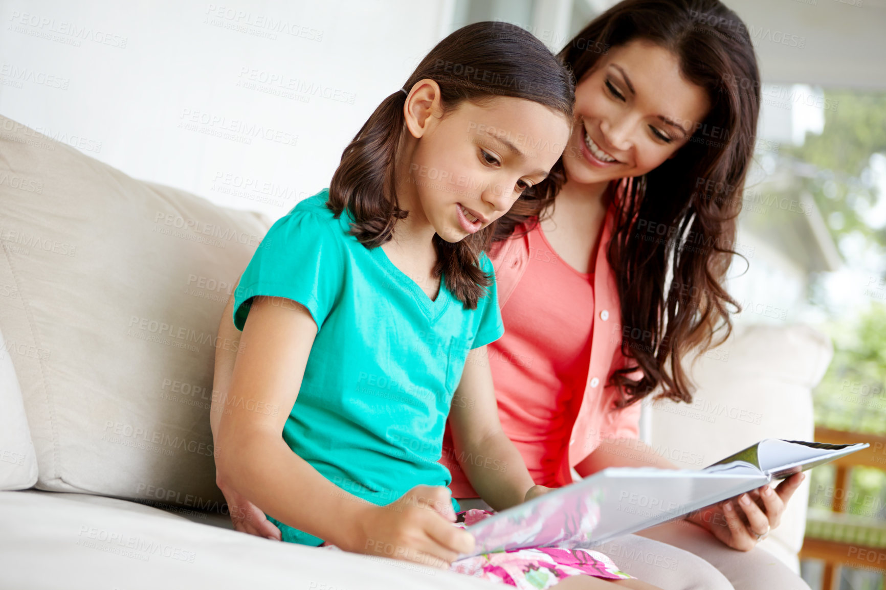 Buy stock photo Studying, mom and daughter with smile, lounge and together with book, reading and woman with girl in home. Happy family, love and kid with parent in living room, story and bonding with child in house