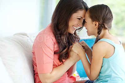 Buy stock photo A mother and daughter sitting on a sofa and sharing a moment with copyspace